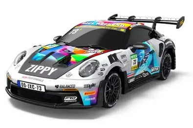 A white Porsche 911 GT3 race car with a vibrant multicolor livery, including 'ZIPPY' and 'BALANCE' branding, shown on a clean white background.