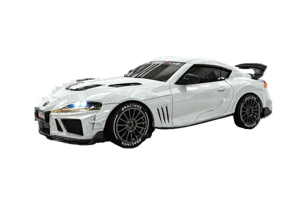 A white Toyota Supra model car with black accents, including a rear spoiler, black wheels, and black hood vents, shown against a plain white background.