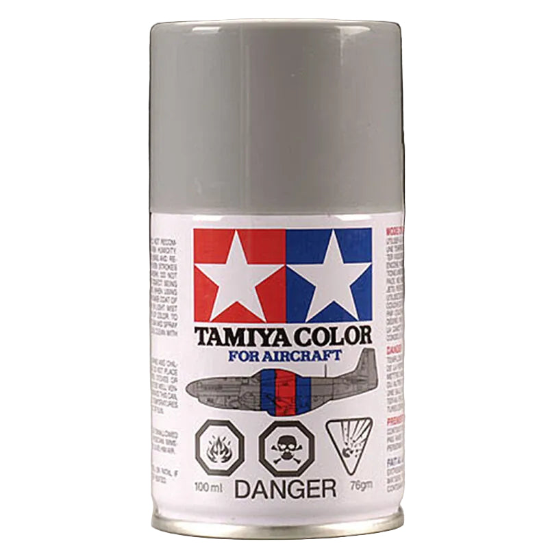 A can of Tamiya Color spray paint for aircraft, featuring a white body with the red and blue Tamiya logo and a gray airplane illustration on the label.